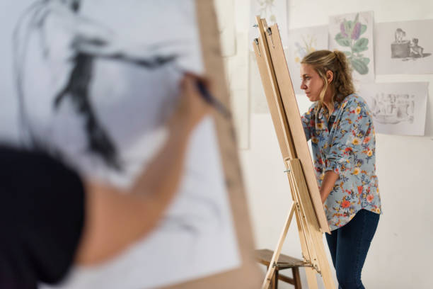 istock Woman working on painting 860407442