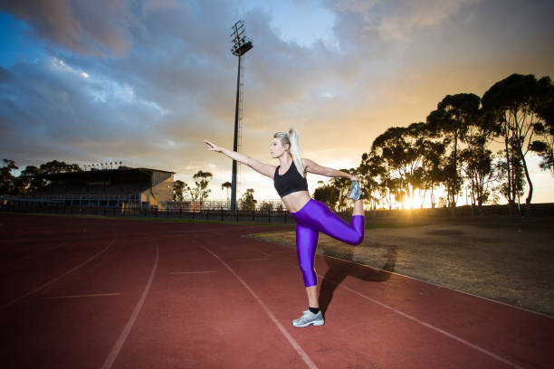 istock Female sprinter athlete getting ready to start a race on a tartan racetrack 860407980