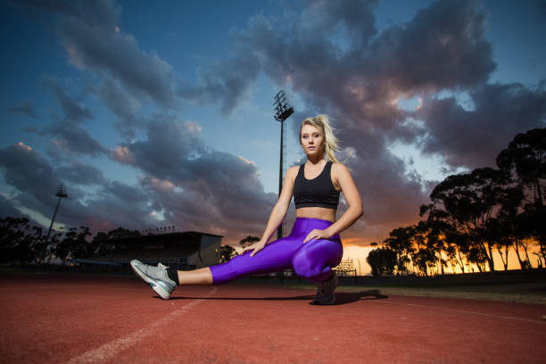 istock Female sprinter athlete getting ready to start a race on a tartan racetrack. 860414200
