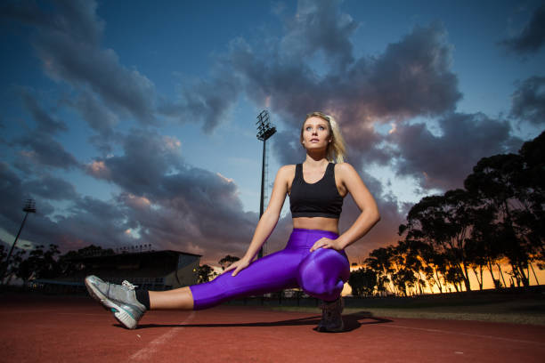istock Female sprinter athlete getting ready to start a race on a tartan racetrack. 860414208