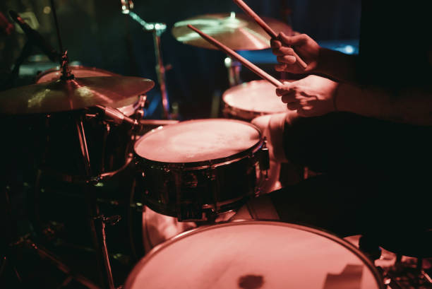 istock Drummer playing his drum kit on concert in club 860414380
