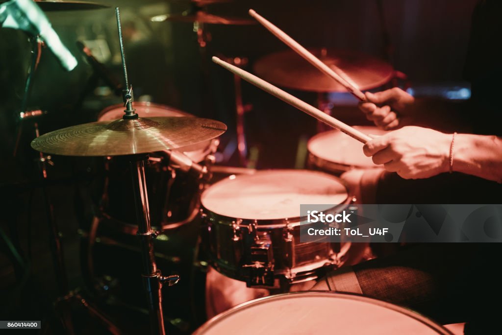 Drummer playing his drum kit on concert in club Drummer playing his drum kit on concert Drum - Percussion Instrument Stock Photo