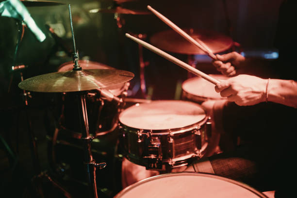 Drummer playing his drum kit on concert in club Drummer playing his drum kit on concert drummer stock pictures, royalty-free photos & images