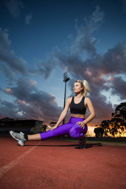 istock Female sprinter athlete getting ready to start a race on a tartan racetrack. 860414512
