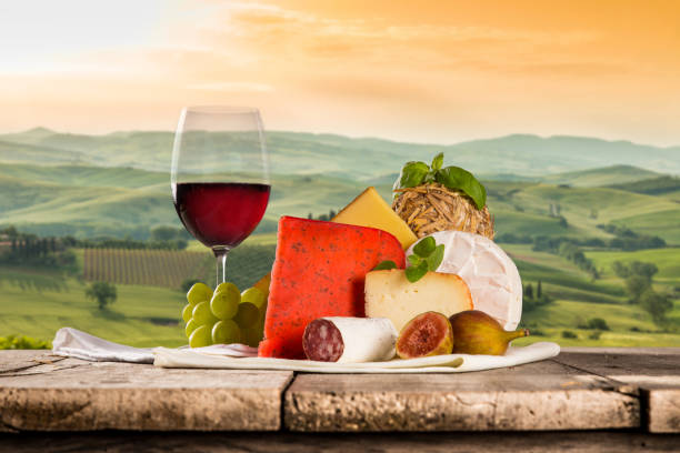 istock Delicious cheeses with wine on old wooden table 860415566