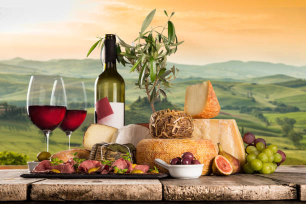 istock Delicious cheeses with wine on old wooden table 860415654