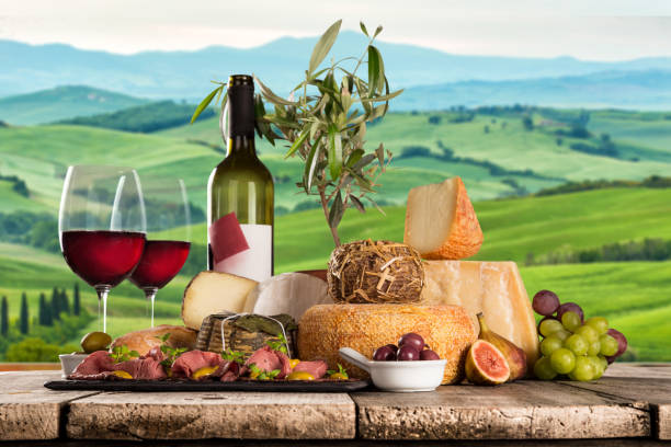 istock Delicious cheeses with wine on old wooden table 860415674