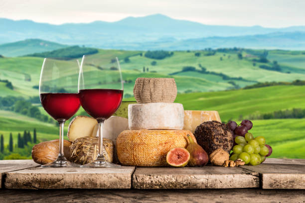 istock Delicious cheeses with wine on old wooden table 860415778