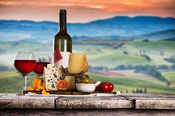 istock Delicious cheeses with wine on old wooden table 860416032