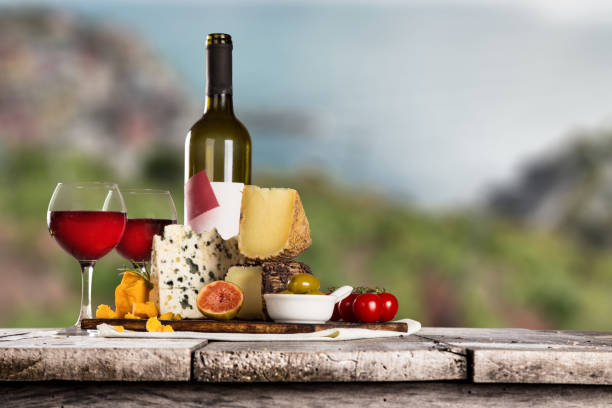 istock Delicious cheeses with wine on old wooden table 860416082