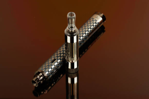 istock Electronic cigarette (vape) in the sorted look against a dark background. 860420028