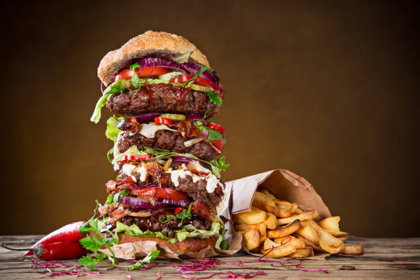 istock Tasty big burger on wooden table 860420194