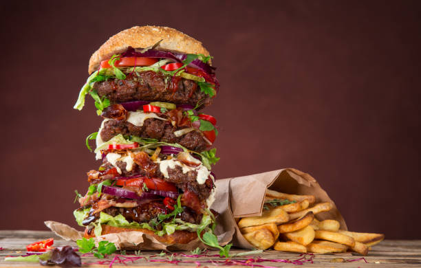 tasty big burger on wooden table - burger hamburger large food imagens e fotografias de stock