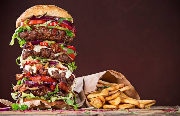 istock Tasty big burger on wooden table 860420492