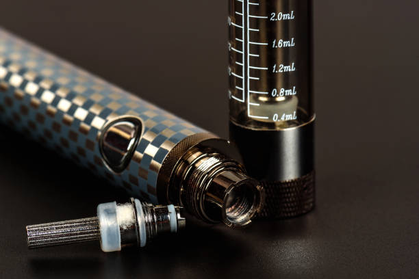 istock Electronic cigarette (vape) in the sorted look against a dark background. 860420916