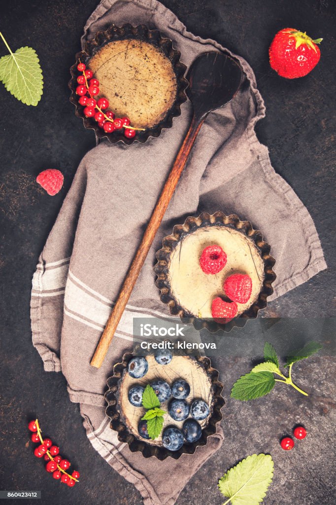 Baking concept Antique Tartlet tins and ingredients on vintage table. Top view. Rustic background with free text space Above Stock Photo