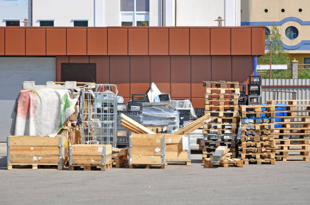 istock Store unloading. Different containers for storage and transportation of products and wooden pallets. 860424806