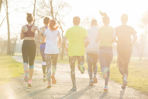 istock Rear view of joggers in park 860427378