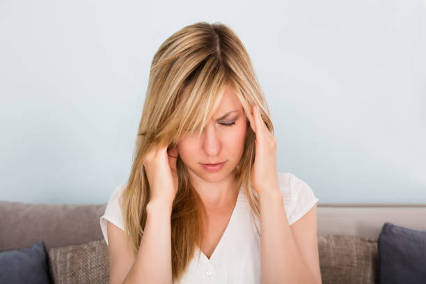 istock Woman Suffering From Headache At Home 860427562