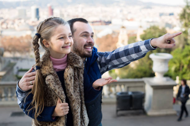 istock positive father and daughter pointing at sight during sightseeing tour 860428106