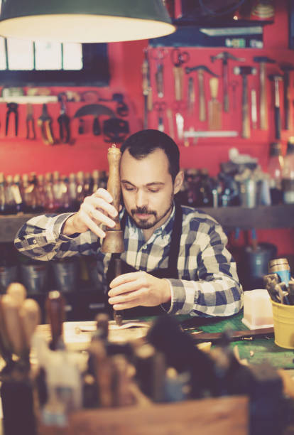 istock Male worker working on leather for belt in leather 860428656