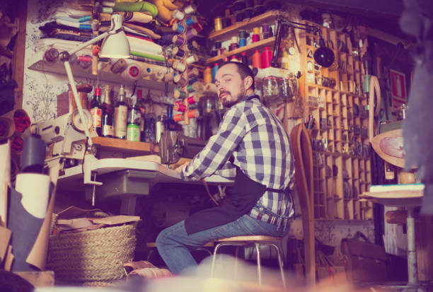 istock Male worker stitching new belt 860428872