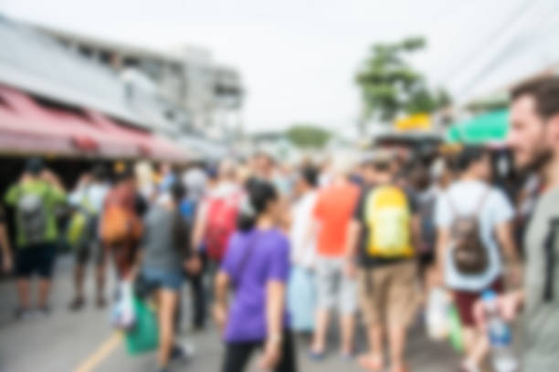 istock Blurred image of people walking at market 860431406