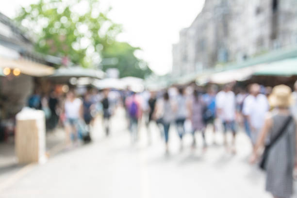 istock Blurred image of people walking at market 860431792