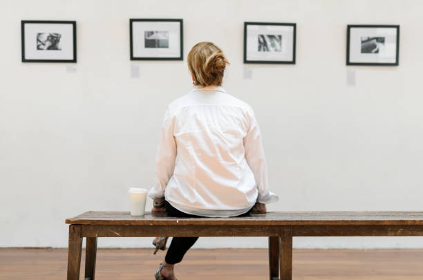 istock Woman looking at frames in an exhibition 860431862