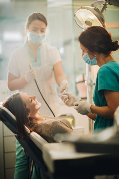 istock Young happy woman having an appointment at dentist's office. 860432948