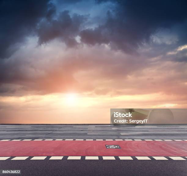 Bicycle Lane And Dramatic Sunset Sky Stock Photo - Download Image Now - Sunset, Wet, Asphalt