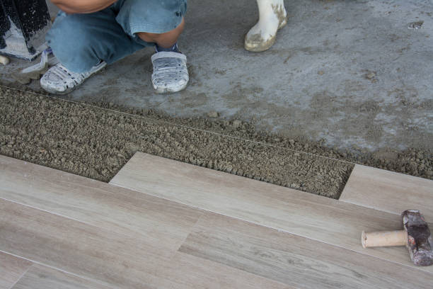 istock laying ceramic wood tiles on wall, installing tiles  in construction site. 860439156