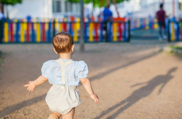 istock Little baby boy running towards playground 860439760