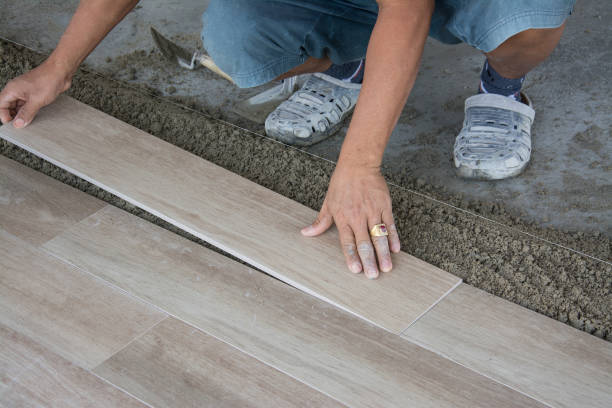 istock laying ceramic wood tiles on wall, installing tiles  in construction site. 860440436