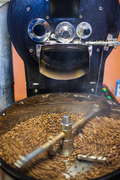 istock Freshly roasted coffee beans being poured into a cooling down rotater. 860440652