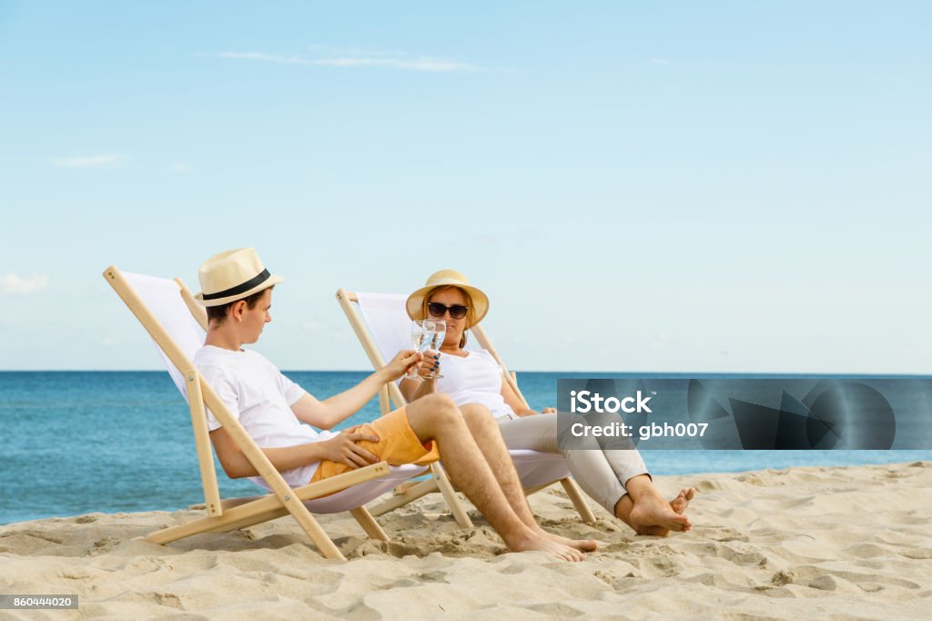 Woman and man relaxing on beach Beach Stock Photo