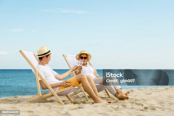 Woman And Man Relaxing On Beach Stock Photo - Download Image Now - Beach, Alcohol - Drink, Baltic Sea