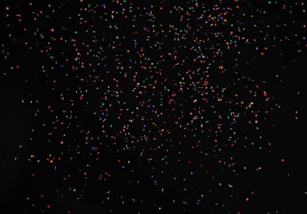 istock Falling shiny colorful particles confetti glitters texture on black background 860444200