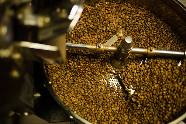 istock Freshly roasted coffee beans being poured into a cooling down rotater 860450130