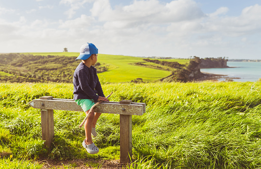 Mixed race kid enjoying outdoors and the authenticity of connecting with nature in Auckland, New Zealand.