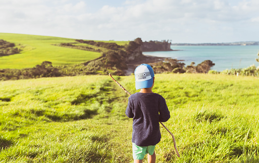 Mixed race kid enjoying outdoors and the authenticity of connecting with nature in Auckland, New Zealand.