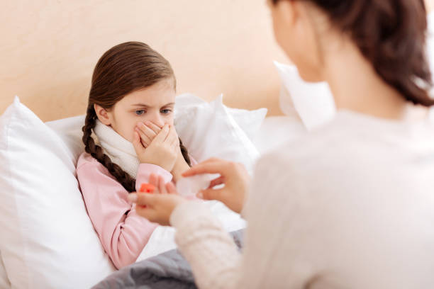 istock Scared child rejecting to take her pills 860454428