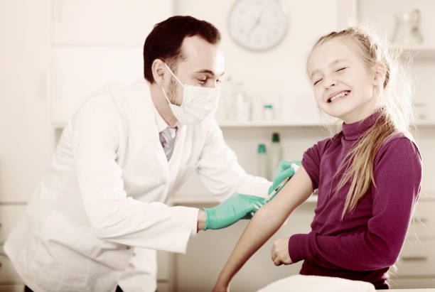 istock Male doctor injecting little patient 860454564