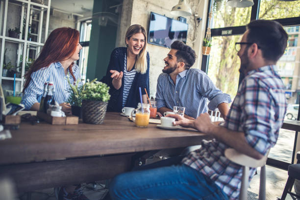 istock Group of cheerful friends having fun while talking in a cafe. 860454746