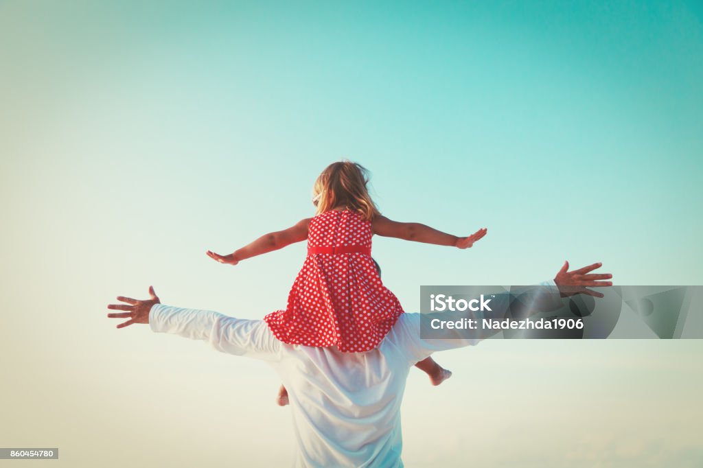 father and little daughter play at sky happy father and little daughter play at sky Father Stock Photo