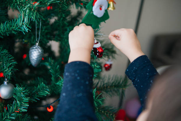 istock Cute little boy decorating christmas tree 860455412