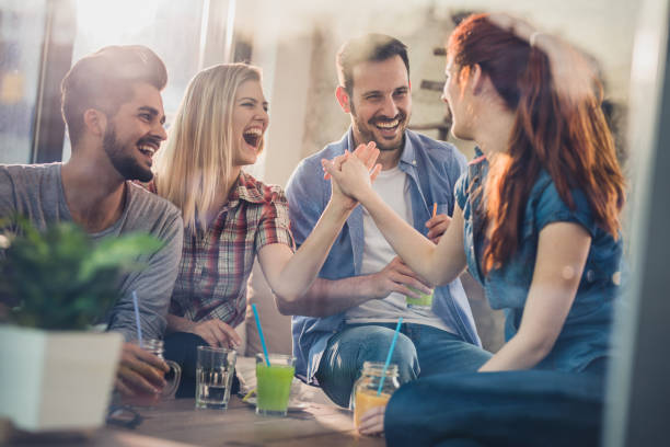 istock Group of cheerful friends having fun in a cafe. 860456170