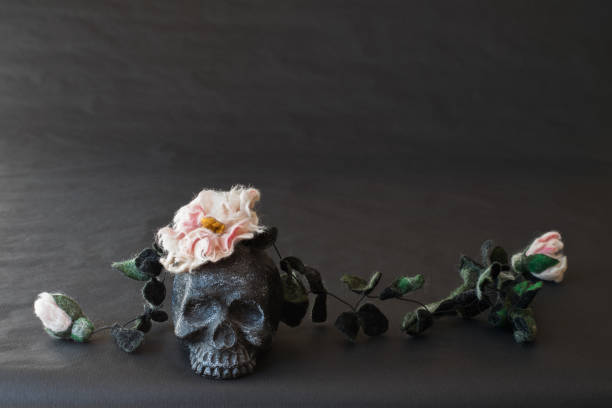 istock Black skull with flowers and leaves. 860459414