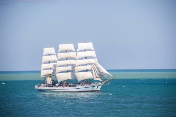 istock old historical tall ship with white sails in blue sea 860462508