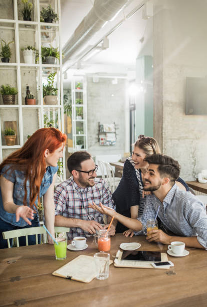 istock Young cheerful people enjoying in a cafe and communicating. 860462656